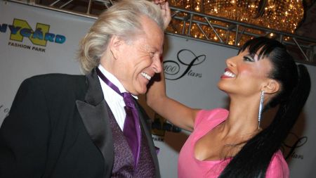 Peter Nygard in a black suit caught in camera with girlfriend.